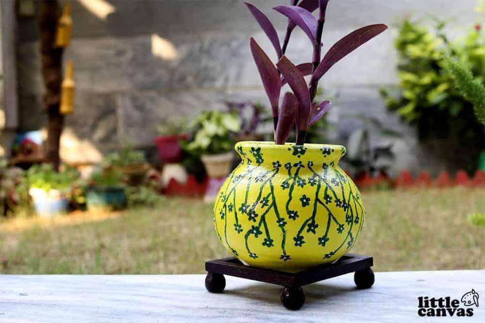 Modern hand decorated terracotta flower pot with yellow and green butterflies 